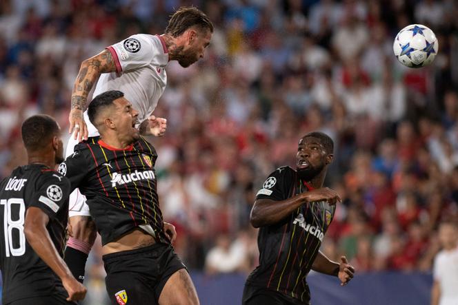 Sevilla's Spanish defender #04 Sergio Ramos (TOP) wins a header over Lens’ Austrian defender #04 Kevin Danso during the UEFA Champions League 1st round day 1 group B football match between Sevilla FC and RC Lens at the Ramon Sanchez Pizjuan stadium in Seville on September 20, 2023.
