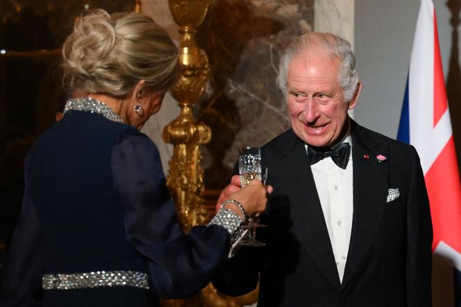 Britain's King Charles III (R) toasts with French president's wife Brigitte Macron (L) during a state banquet at the Palace of Versailles, west of Paris, on September 20, 2023, on the first day of a British royal state visit to France.
