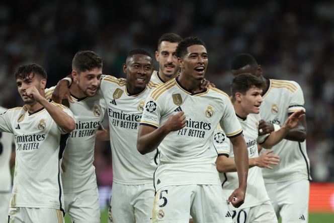 Real Madrid's English midfielder #5 Jude Bellingham celebrates with teammates scoring his team's first goal during the UEFA Champions League 1st round day 1 group C football match between Real Madrid and Union Berlin at the Santiago Bernabeu stadium in Madrid on September 20, 2023.