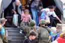In this handout videograb of a footage taken and released by the Russian Defence Ministry on September 20, 2023, Russian peacekeepers help to evacuate refugees from Stepanakert, as Azerbaijan's renewed offensive on the region. Karabakh authorities claimed 25 people, including two civilians, were killed in the fighting, while Azerbaijan warned it would "continue until the end" in the territory. - RESTRICTED TO EDITORIAL USE - MANDATORY CREDIT "AFP PHOTO/ HANDOUT / RUSSIAN DEFENCE MINISTRY" - NO MARKETING NO ADVERTISING CAMPAIGNS - DISTRIBUTED AS A SERVICE TO CLIENTS (Photo by RUSSIAN DEFENCE MINISTRY / AFP) / RESTRICTED TO EDITORIAL USE - MANDATORY CREDIT "AFP PHOTO/ HANDOUT / RUSSIAN DEFENCE MINISTRY" - NO MARKETING NO ADVERTISING CAMPAIGNS - DISTRIBUTED AS A SERVICE TO CLIENTS