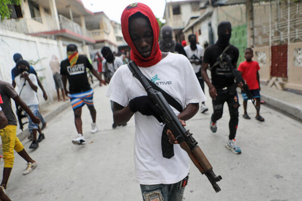 Former police officer Jimmy "Barbecue" Cherizier (not pictured), leader of the 'G9' coalition, is accompanied by Security during a march against Haiti's Prime Minister Ariel Henry, in Port-au-Prince, Haiti September 19, 2023. REUTERS/Ralph Tedy Erol
