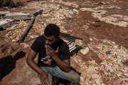 Abdallah sits among the ruins of his hamlet in eastern Libya on September 20