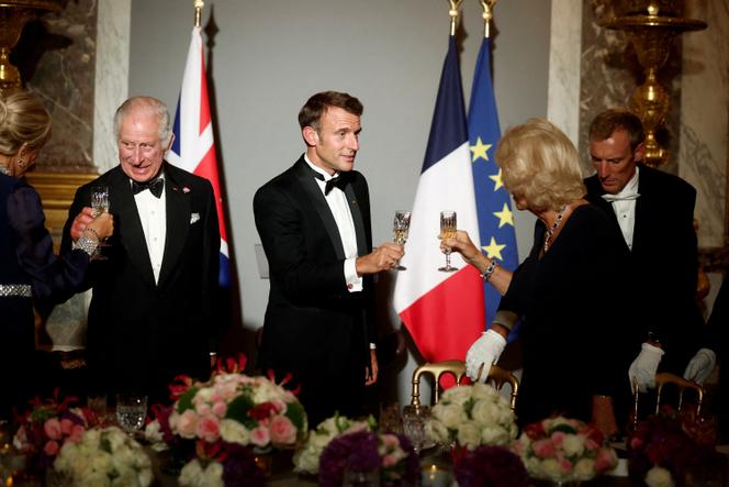 French President Emmanuel Macron, his wife Brigitte Macron, British King Charles and Queen Camilla toast during a state dinner in the Galerie des Glaces at the Château de Versailles in Versailles on the first day of their official visit to France, September 20, 2023.