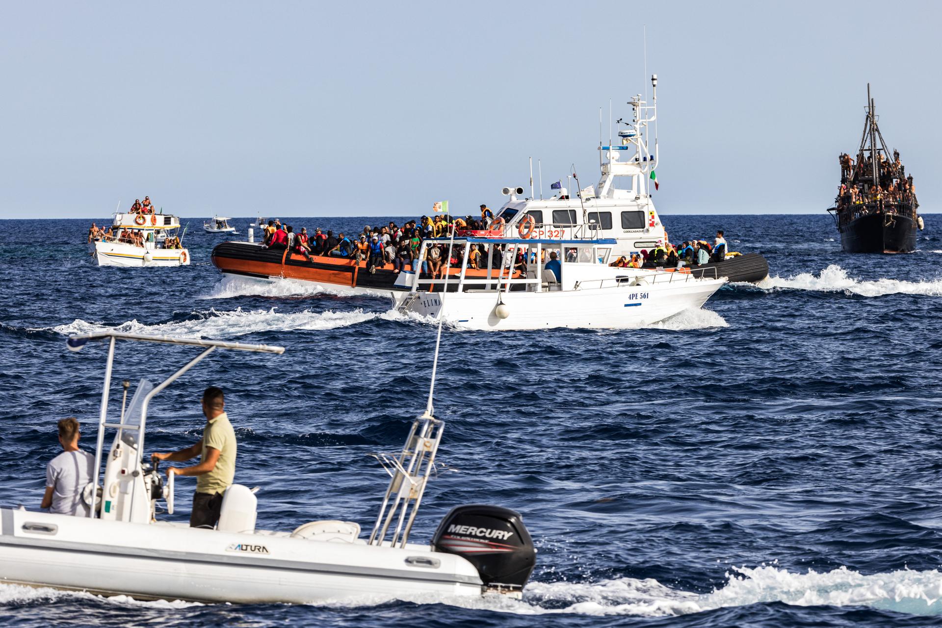 Rescued migrants arrive at Lampedusa's Favaloro pier, aboard an Italian coastguard launch, September 18, 2023.