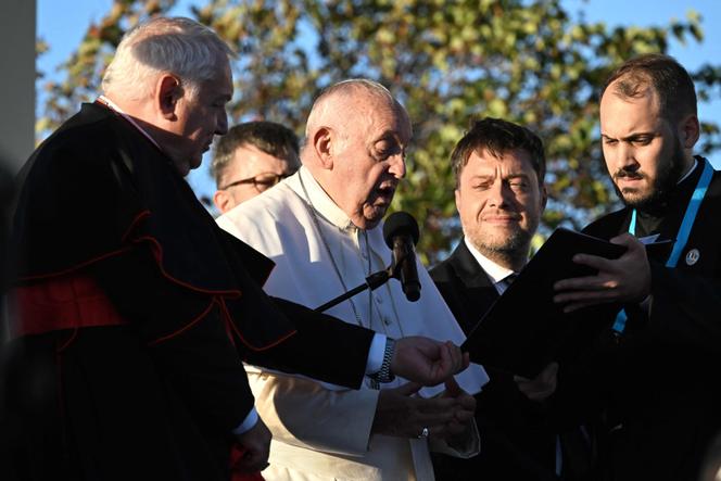 Pope Francis, next to Marseille's Archbishop and Cardinal Jean-Marc Aveline (left) and Marseille's mayor Benoit Payan (2nd right), delivers a speech during a homage at the memorial dedicated to sailors and migrants lost at sea at the Basilica of Notre-Dame de la Garde in Marseille, France, on September 22, 2023. 