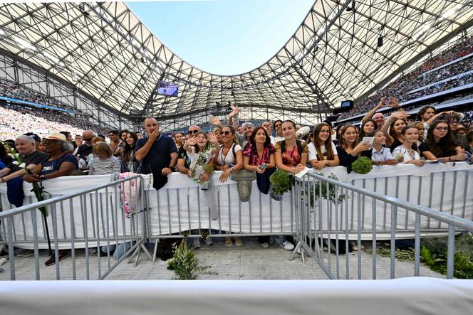 People listen to Pope Francis as he celebrates mass at the Velodrome stadium, in the southern port city of Marseille on September 23, 2023.