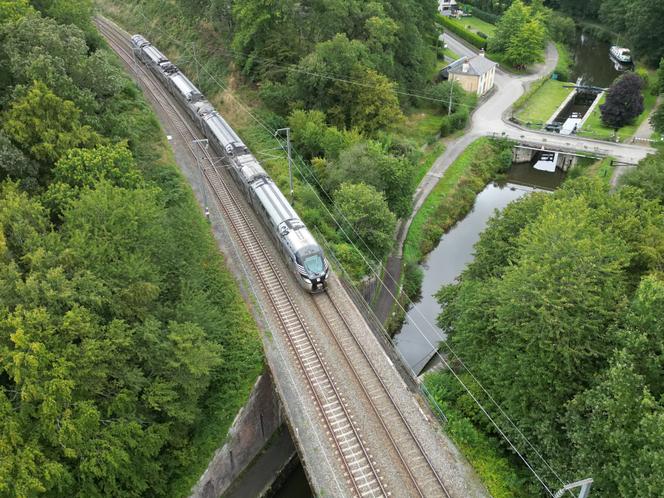 A regional express train (TER) passing over the Ille et Rance canal, at Saint-Médard-sur-Ille (Ille-et-Vilaine, western France), July 28, 2023