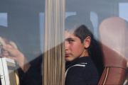 A refugee from the Nagorno-Karabakh region looks out of a bus upon at a checkpoint in the village of Kornidzor, Armenia, September 24, 2023. 