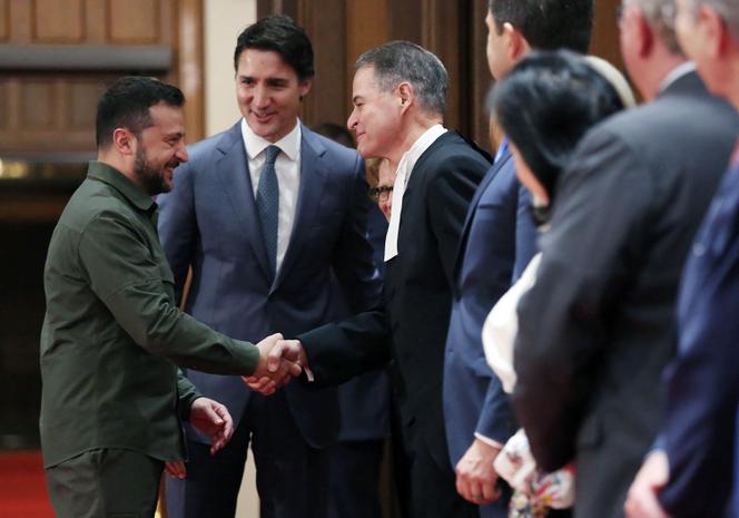Ukrainian President Volodymyr Zelensky, with Prime Minister Justin Trudeau (C), shake hands with House of Commons Speaker Anthony Rota during a ceremony on Parliament Hill on September 22, 2023 in Ottawa, Canada. 