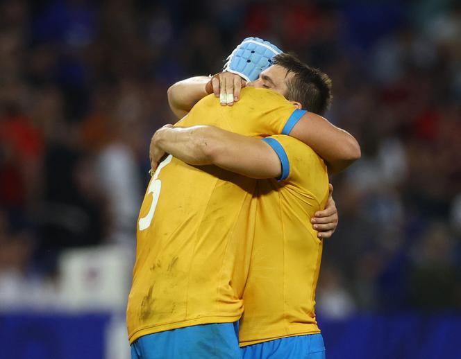 Uruguay rugby players celebrate after their match against Namibia in Lyon, France, on September 27, 2023.
