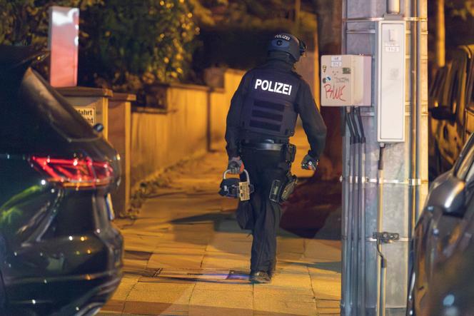A police officer during a raid of homes in Essen, Germany, connected with the far-right group, September 27, 2023. 
