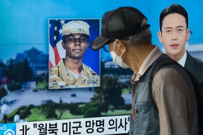 A man walks past a television showing a news broadcast featuring a photo of US soldier Travis King, who ran across the border into North Korea during a tourist visit to the Demilitarized Zone on South Korea's border on July 18.