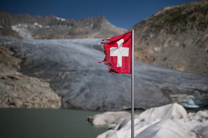 The Swiss flag flies near the Rhone Glacier in the Alps on August 24, 2023. 