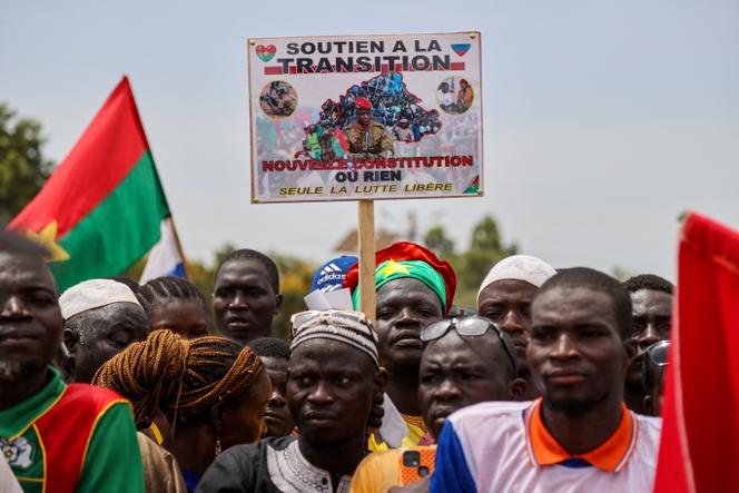 A person holds a sign with a picture of Captain Ibrahim Traore while attending a rally by supporters of Burkina Faso's junta to mark the one-year anniversary of the coup that brought Traore to power in Ouagadougou, Burkina Faso September 29, 2023.