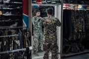 A Ukrainian man trying on a military uniform in a store in downtown Odesa (Ukraine), September 23, 2023.