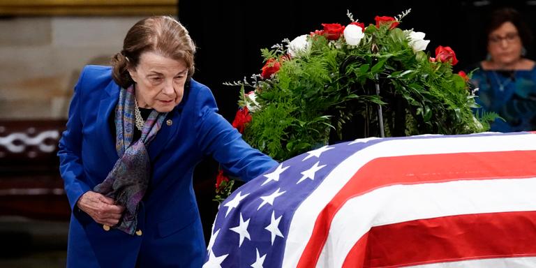 Ken Cedeno/AP FILE - Sen. Dianne Feinstein, D-Calif. touches the flag-draped casket of former Sen. Bob Dole, of Kansas, as he lies in state in the Rotunda of the U.S. Capitol in Washington, Thursday, Dec. 9, 2021. (Ken Cedeno/Pool Photo via AP, File)