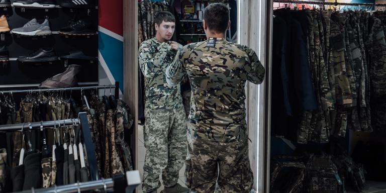ADRIEN VAUTIER/LE PICTORIUM FOR LE MONDE A Ukrainian tries on a military uniform in a downtown store. Odessa, September 23, 2023.