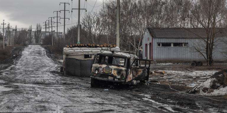 LAURENT VAN DER STOCKT FOR LE MONDE Bakhmut, Donetsk Oblast, Ukraine, February 25, 2022. The last access road to the Donbas town of Bakhmut, around which Russian forces are tightening their grip. At the entrance to the town, one of the ambulances bringing in the wounded lies charred, having been hit by a rocket the day before. Laurent Van der Stockt for Le Monde.