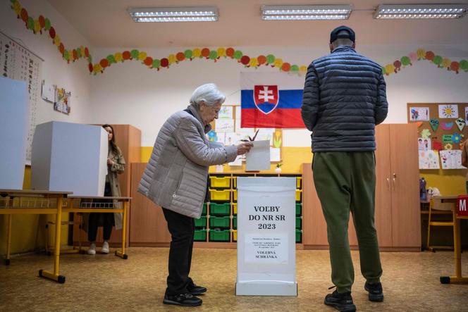Voters arrive to cast their ballots into an urn at a polling station during the Slovak parliamentary election in downtown Bratislava, Slovakia on September 30, 2023. 