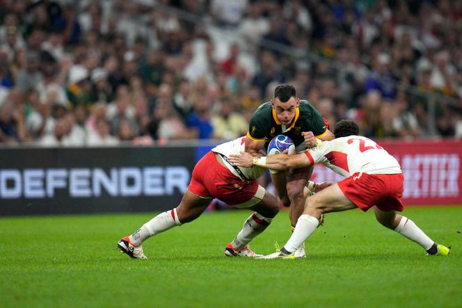 South Africa's Jesse Kriel, centre, is tackled by Tonga's Pita Ahki, left, and teammate Patrick Pellegrini during the Rugby World Cup Pool B match between South Africa and Tonga at the Marseille's Stade Velodrome, in Marseille, France Sunday, Oct. 1, 2023.
