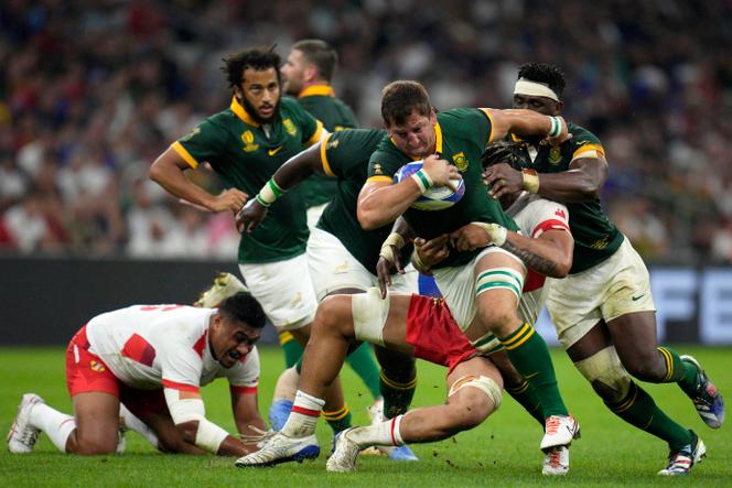 South Africa's Kwagga Smith, front, is tackled from behind by Tonga's captain Halaleva Fifita during the Rugby World Cup Pool B match between South Africa and Tonga at Marseille's Stade Velodrome, in Marseille, France Sunday, October 1, 2023.