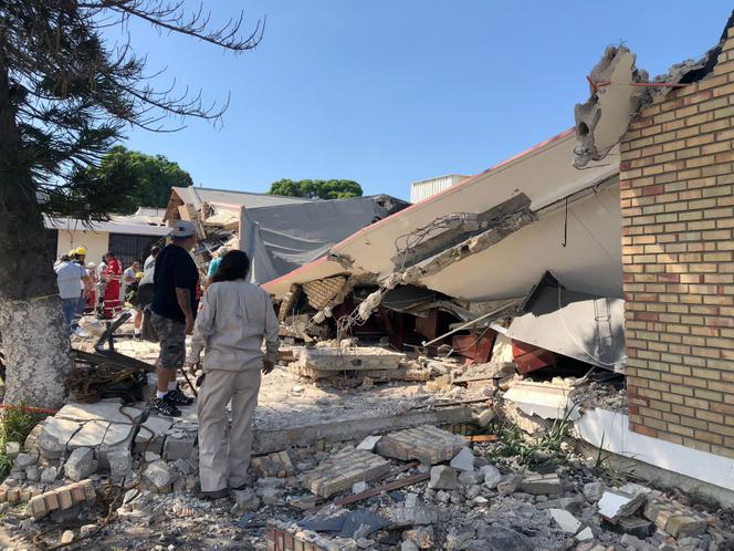 Members of a rescue team and people work at a site where a church roof collapsed during Sunday mass in Ciudad Madero, in Tamaulipas state, Mexico in this handout picture distributed to Reuters on October 1, 2023. 