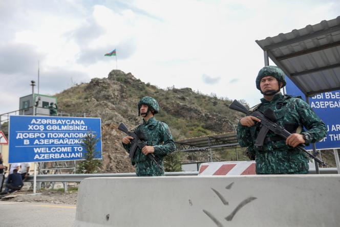 Azerbaijani servicemen guard the Lachin checkpoint on the corridor in Azerbaijan, Sunday, Oct. 1, 2023.