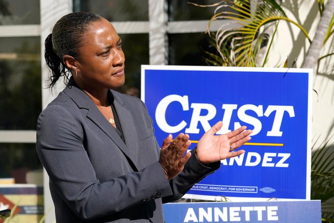 Laphonza Butler, president of EMILY's List, listens during a rally held by the Latino Victory Fund, October 20, 2022, in Coral Gables, Florida.
