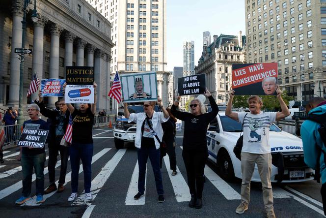 Demonstrators block traffic on the first day of the Trump financial fraud trial at the New York County Court House on October 2, 2023 in New York City.