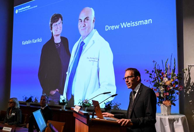 Member of Nobel Assembly at the Karolinska Institute Thomas Perlmann speaks in front of a picture of this year's laureates to the media during the announcement of the winners of the 2023 Nobel Prize in Physiology or Medicine at the Karolinska Institute in Stockholm on October 2, 2023. 