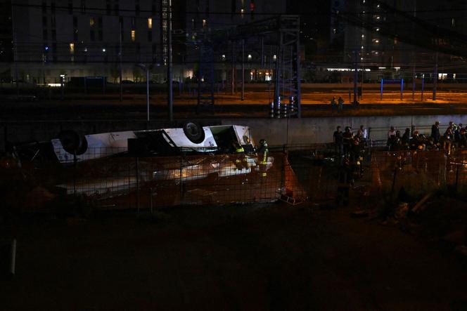 Firefighters work on the site of a bus accident on October 3, 2023 in Mestre, near Venice, Italy. 