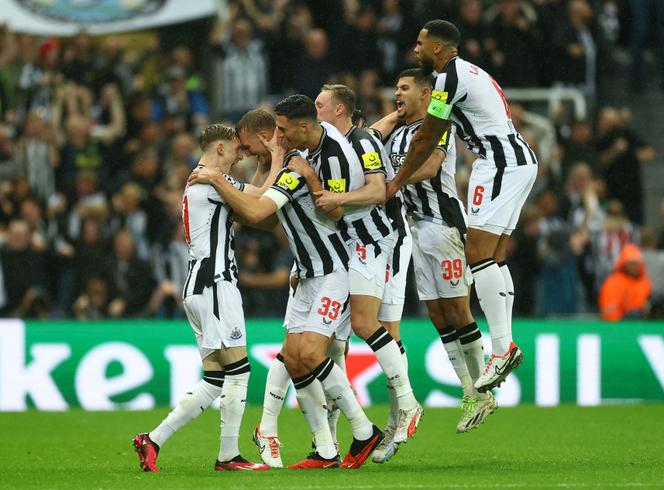 Newcastle United's Dan Burn celebrates scoring their second goal with teammates at St James' Park, Newcastle, Britain on October 4, 2023.
