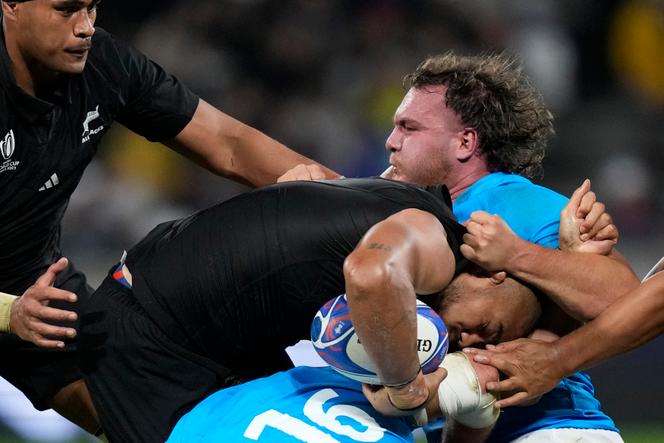 New Zealand's Ofa Tu'ungafasi is tackled by Uruguay's Guillermo Pujadas during the Rugby World Cup Pool A match between New Zealand and Uruguay at the OL Stadium, in Lyon, France Thursday, October 5, 2023.