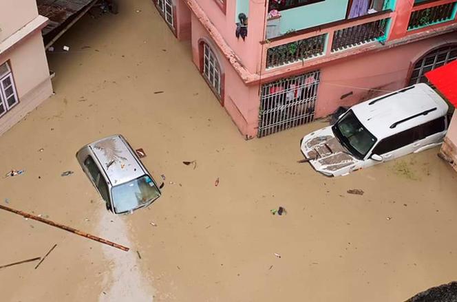 Cars lie submerged in water after flash floods triggered by a sudden heavy rainfall swamped the Rangpo town in Sikkim, India, October 5, 2023.