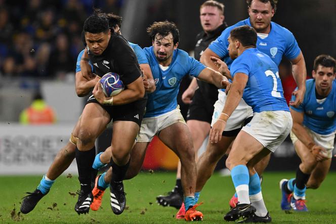 New Zealand's wing Caleb Clarke attempts to break away during the France 2023 Rugby World Cup Pool A match between New Zealand and Uruguay at the OL Stadium in Decines-Charpieu, near Lyon, south-eastern France, on October 5, 2023.
