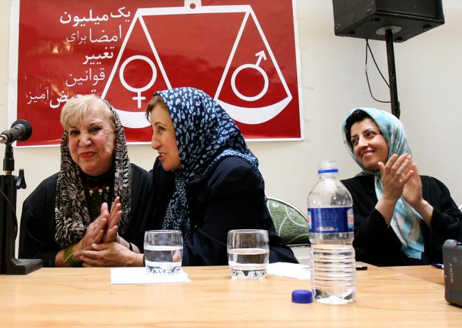 Iranian human rights activist Narges Mohammadi, right, applauds poet Simin Behbahani, left, during a meeting with Iranian Nobel Peace Prize laureate Shirin Ebadi, in Tehran, Iran, on July 3, 2008.