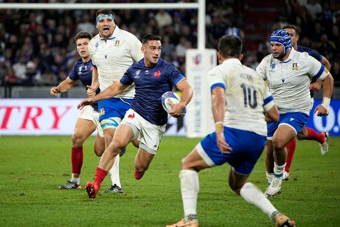France's Baptiste Couilloud, center, runs with the ball during the Rugby World Cup Pool A match between France and Italy at the OL Stadium, in Lyon, France Friday, October 6, 2023.