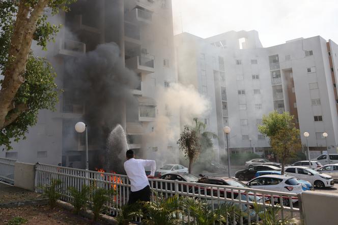 An Israeli youth runs for cover during shelling in Ashkelon as barrages of rockets are fired from the Gaza Strip into Israel on October 7, 2023.