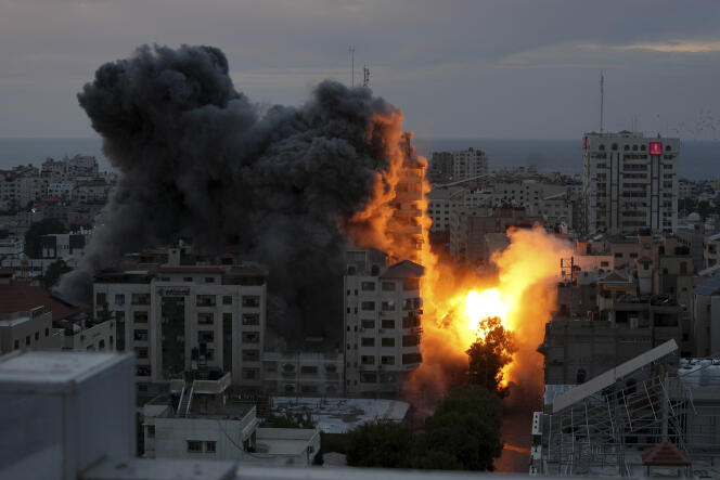 A ball of fire and smoke rises after the explosion of a Palestinian high-rise building following an Israeli air strike in Gaza City on October 7, 2023.
