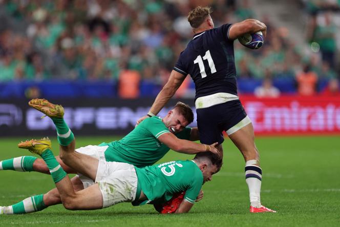 Ireland's fly-half Jack Crowley (L) and Ireland's full-back Hugo Keenan (C) tackle Scotland's wing Duhan van der Merwe (R) during the France 2023 Rugby World Cup Pool B match between Ireland and Scotland at the Stade de France in Saint-Denis, on the outskirts of Paris on October 7, 2023. 