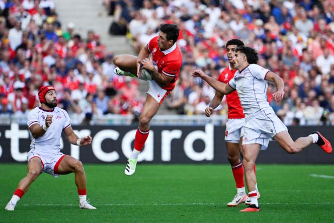 Wales' wing Louis Rees-Zammit (center) leaps to catch a high ball during the France 2023 Rugby World Cup Pool C match between Wales and Georgia at the Stade de la Beaujoire in Nantes, western France on October 7, 2023.