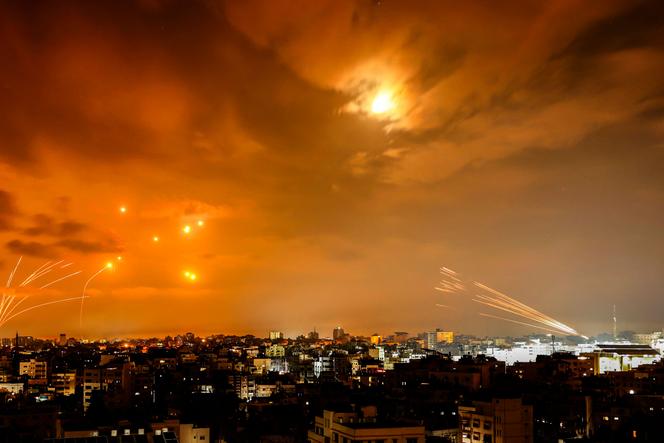 Rockets fired by Palestinian militants from Gaza City are intercepted by the Israeli Iron Dome defense missile system in the early hours of October 8, 2023.