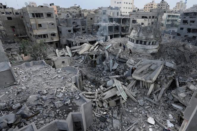 Palestinians inspect the rubble of the Yassin Mosque destroyed after it was hit by an Israeli airstrike at Shati refugee camp in Gaza City, on October 9, 2023.