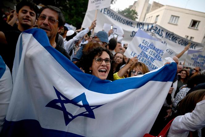 A demonstrator waves the national flag of Israel at a rally called for by the Representative Council of French Jewish Institutions (CRIF) in solidarity with Israel after recent Hamas attacks, in Paris on October 9, 2023.
