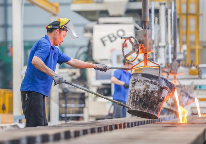 A Chinese worker works with molten steel at a factory in Jinjiang, Fujian province, April 10, 2019.