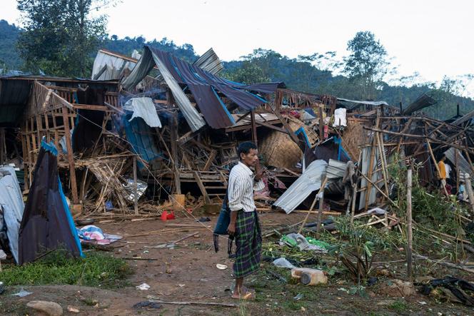 A man looks on at homes destroyed after air and artillery strikes in Mung Lai Hkyet displacement camp, in Laiza, Myanmar, Tuesday Oct. 10, 2023.