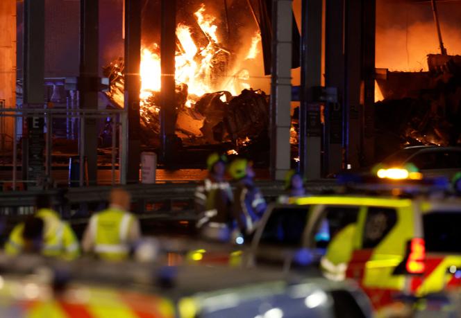 Flames are seen as emergency services respond to a fire in Terminal Car Park 2 at London Luton airport in Luton, Britain, October 10, 2023.