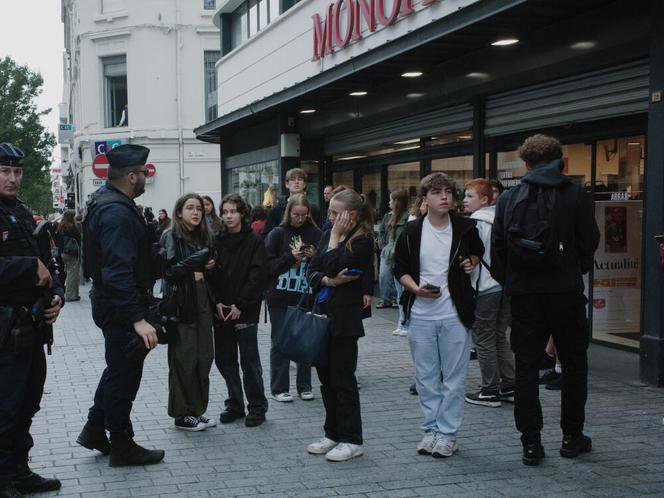 Students wait for their parents to come and get them after a stabbing took place at the Lycée Gambetta in the northern town of Arras.