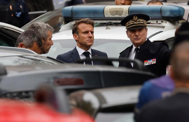 French President Emmanuel Macron (C) arrives at the Gambetta high school in Arras, northeastern France on October 13, 2023, after a teacher was killed and two other people severely wounded in a knife attack, police and regional officials said. The perpetrator has been detained by police, Interior Minister Gerald Darmanin wrote on X, formerly Twitter. (Photo by Ludovic MARIN / AFP)