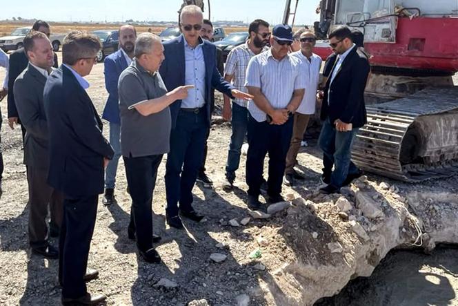 This handout picture released by the Telegram channel of the official Syrian Arab News Agency (SANA) shows Syria's Prime Minister Hussein Arnous inspects damage at the runway of Damascus International Airport on the outskirts of the Syrian capital on October 13, 2023 after an Israeli air strike.